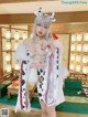 A woman in a cow costume posing for a picture.